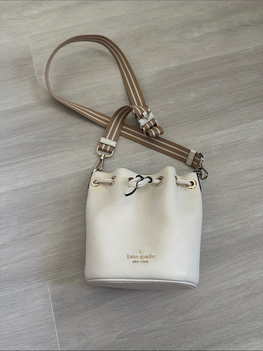 kate spade Cream Pebbled Leather Drawstring Bucket Bag with Striped Strap